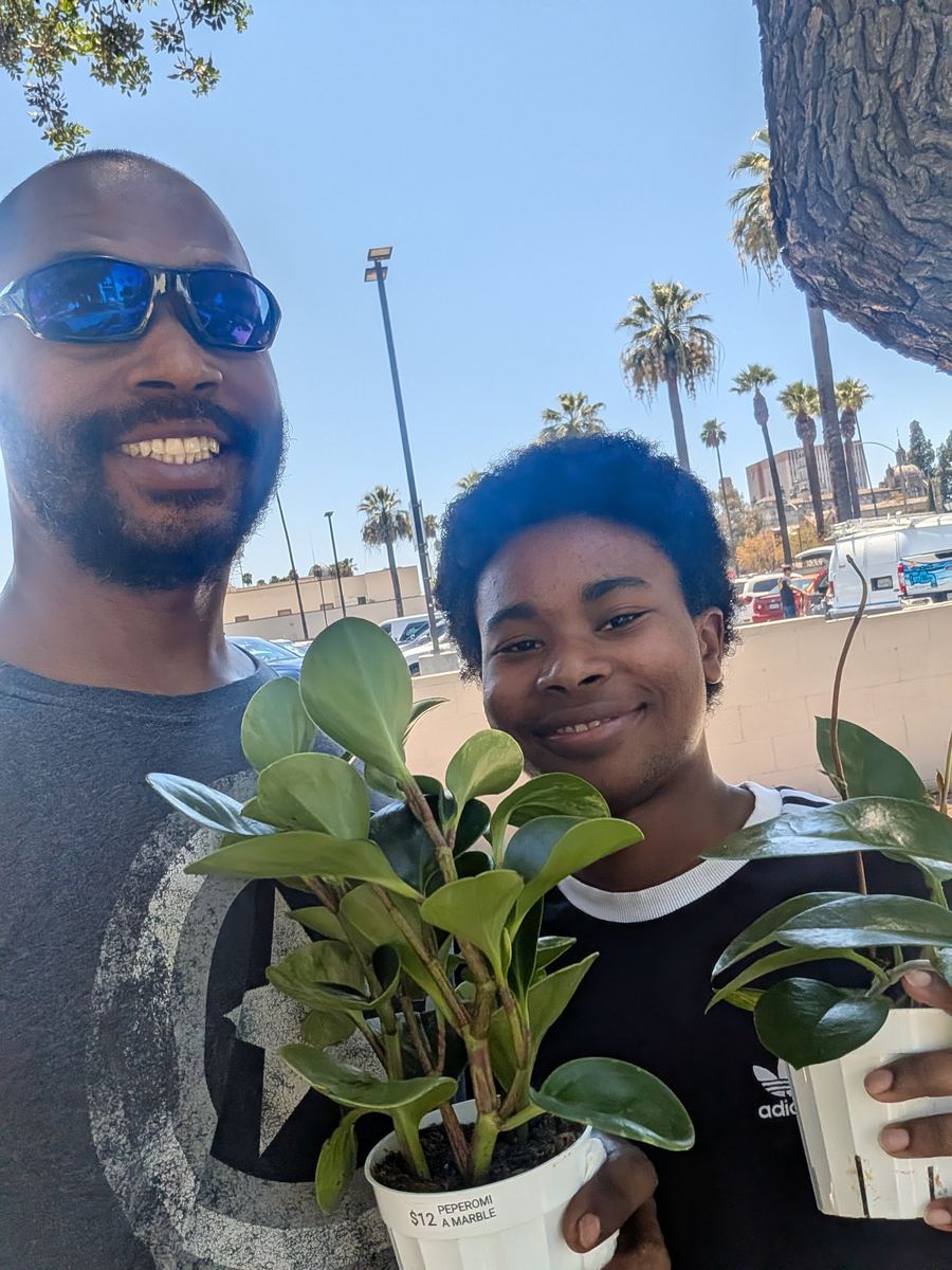 Darryl holding a couple of newly bought potted plants